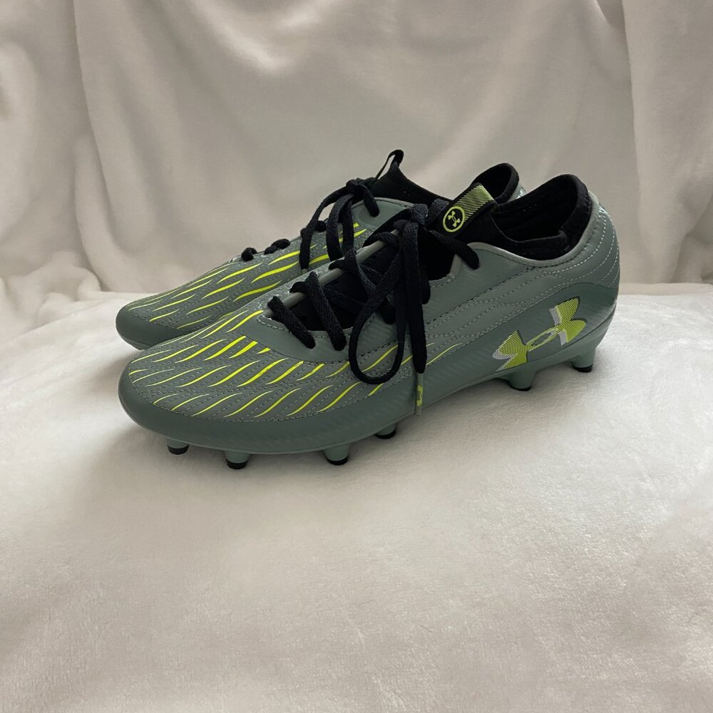 The Under Armour Youth Magnetico Select 4 FG JR Cleats in Green